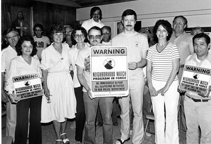 Sylmar Neighborhood Watch group portrait of men and women holding warning signs