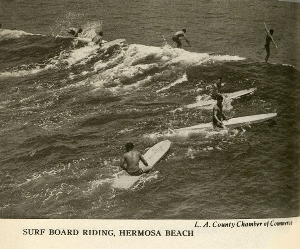7 Men in swimsuits surfing a wave