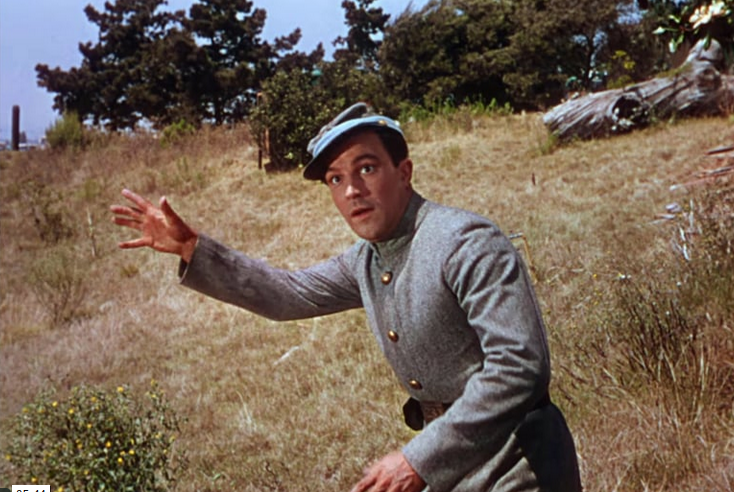 Man in uniform looking surprised on a hill